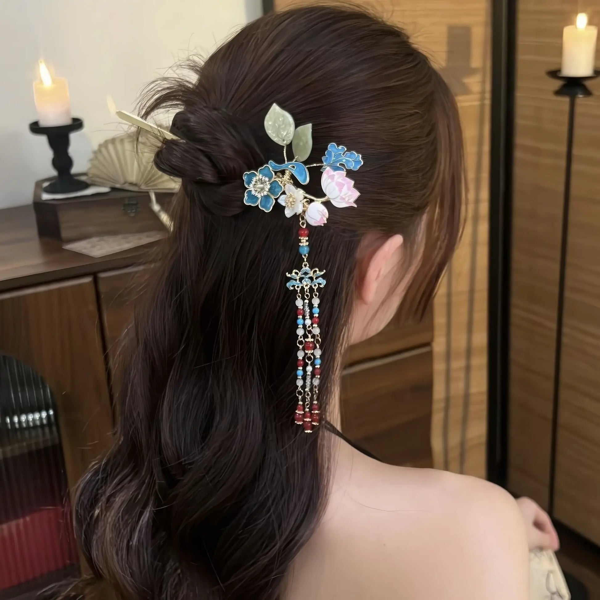 Side profile of the hairpin worn in a low bun, showing the tassel swaying gently against the wearer’s hair and shoulder.