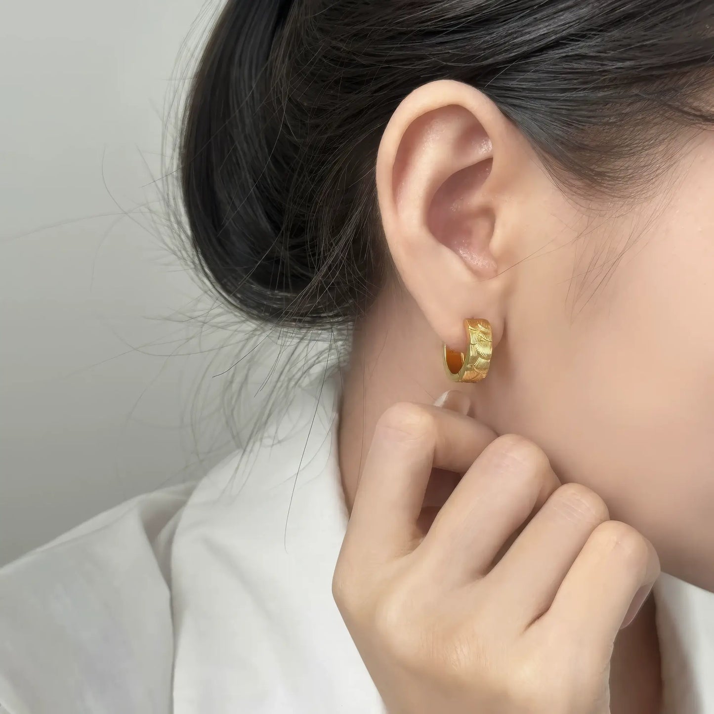  Gold neo - Chinese style koi fish scale earring worn, complementing a white outfit, emphasizing the elegant and unique look.