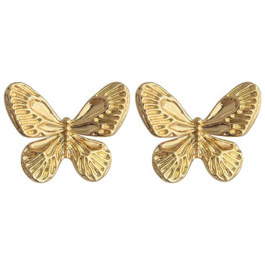 Pair of large gold neo - Chinese textured butterfly stud earrings isolated on white background