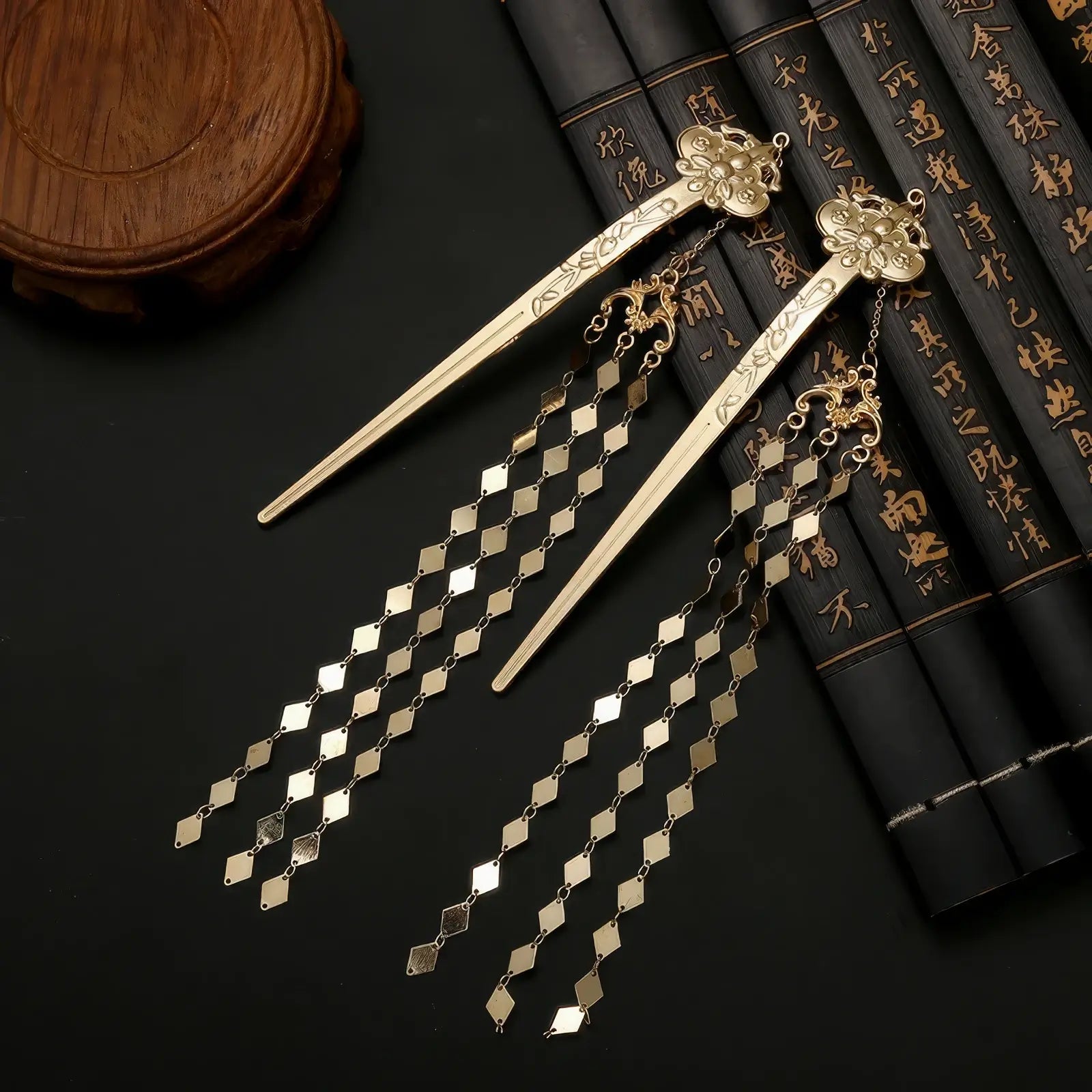 New Chinese - style rhombus - shaped hairpin with tassels placed on a black surface, next to traditional - style books and an object.