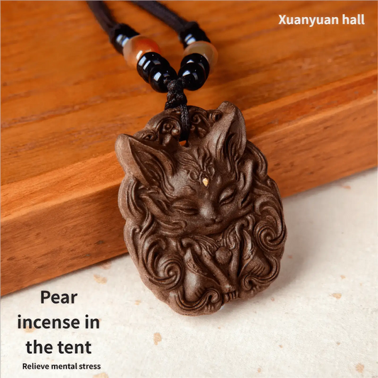  Detailed close - up of a nine - tailed fox incense pendant on a wooden background, focusing on the fine carvings and the texture of the dark - brown pendant.
