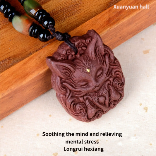 Side close - up of a nine - tailed fox incense pendant on a wooden surface, presenting the side profile and the details of the fox - shaped carving on the reddish - brown pendant.
