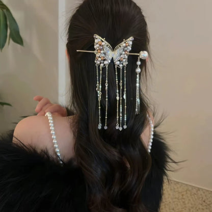 Rear view of long wavy half-up hair styled with the complete butterfly pearl tassel hairpin set, highlighting the flowing layered tassels.