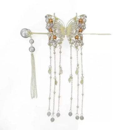 Silver-toned wire butterfly hairpin decorated with mixed pearls and crystal beads, matched with an independent pearl tassel hair stick, displayed on clean white background to show all delicate layered tassels with leaf pendants.