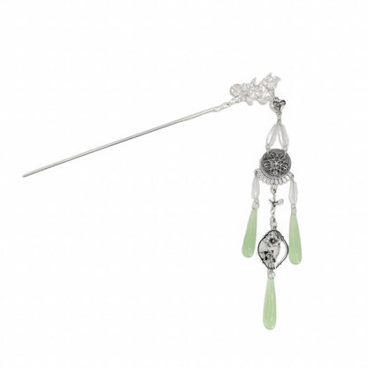 A full view of the retro silver wind chime hairpin isolated against a white background, clearly showing the silver floral top, wind chime centerpiece, and jade-green tassels.