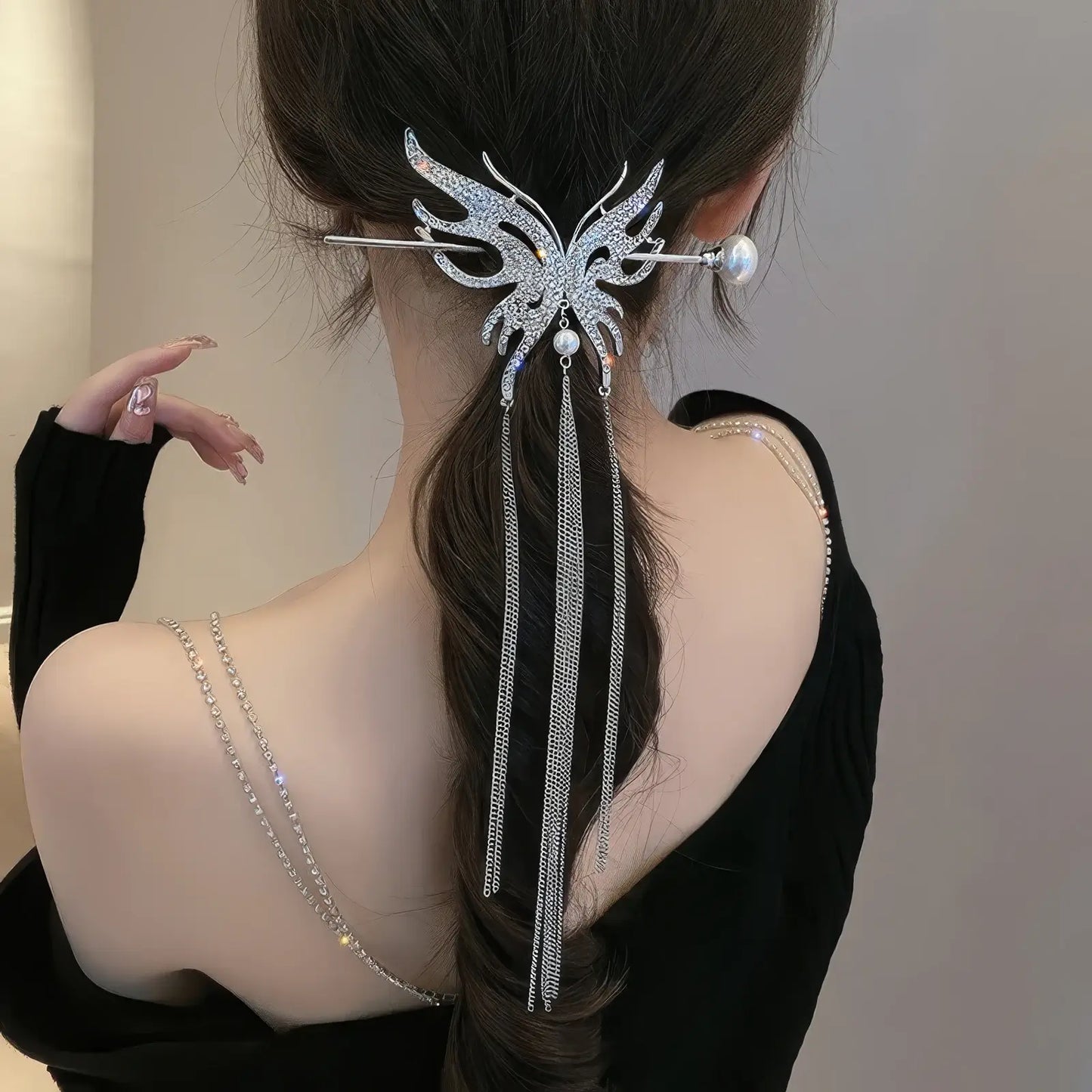 Rear side shot of low ponytail matched with full rhinestone butterfly tassel hairpin set, thin chain tassels swing naturally with hair movement.
