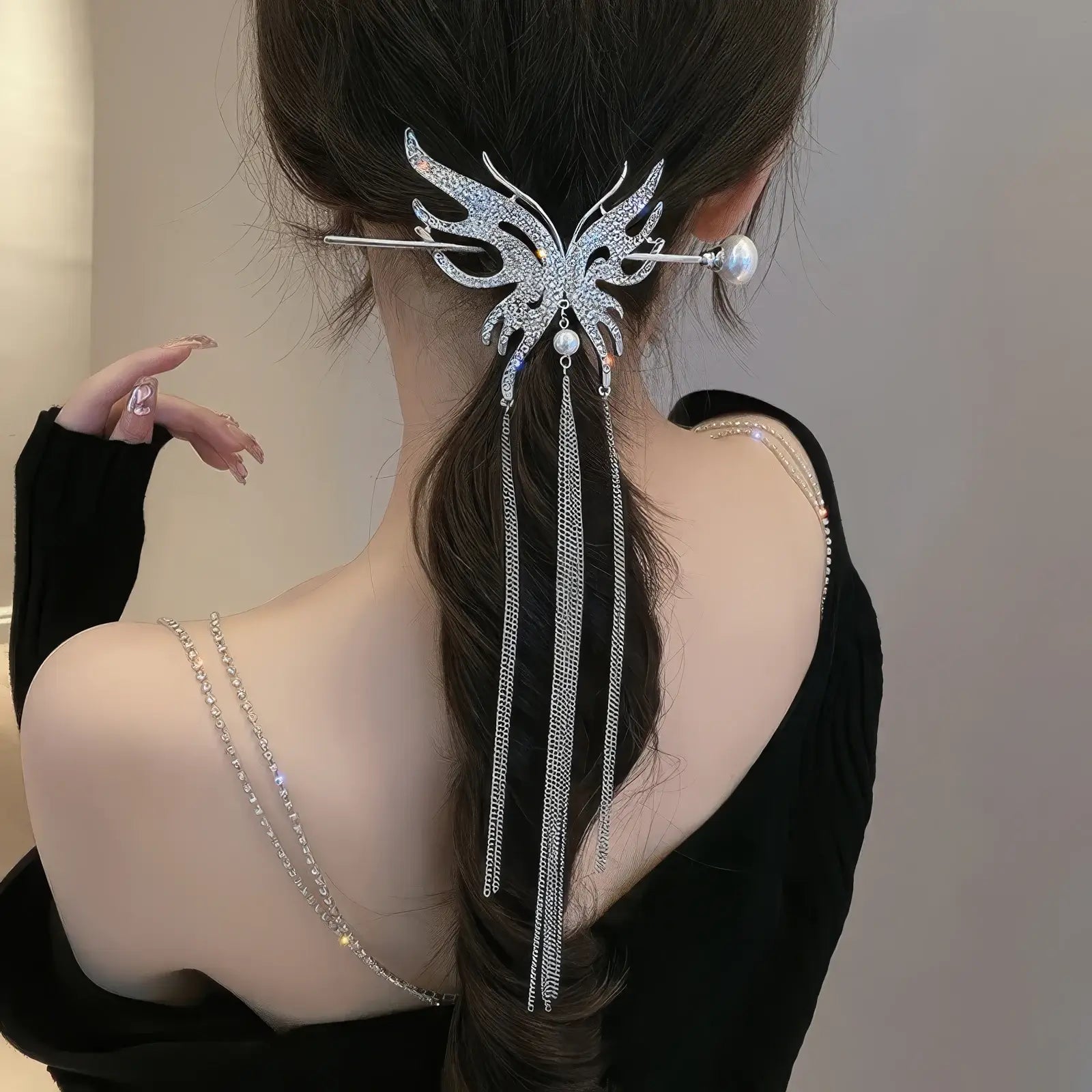 Rear side shot of low ponytail matched with full rhinestone butterfly tassel hairpin set, thin chain tassels swing naturally with hair movement.