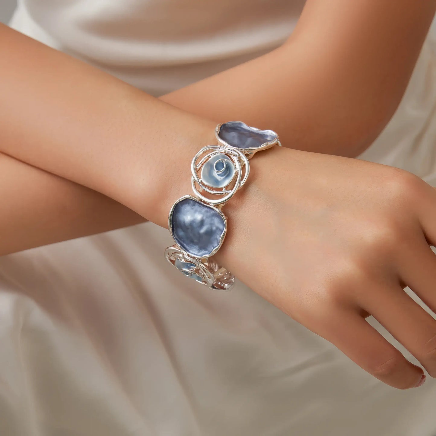  Rose - themed bracelet worn on wrist, highlighting the design and stones.