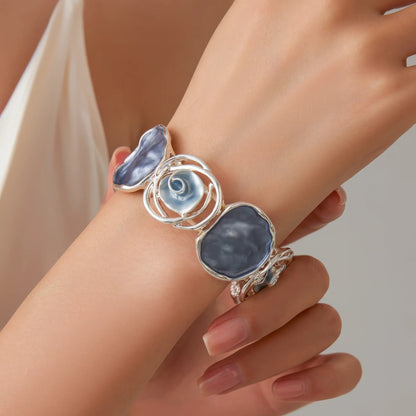 Rose - themed bracelet worn on wrist, showcasing the silver and blue - stone design.