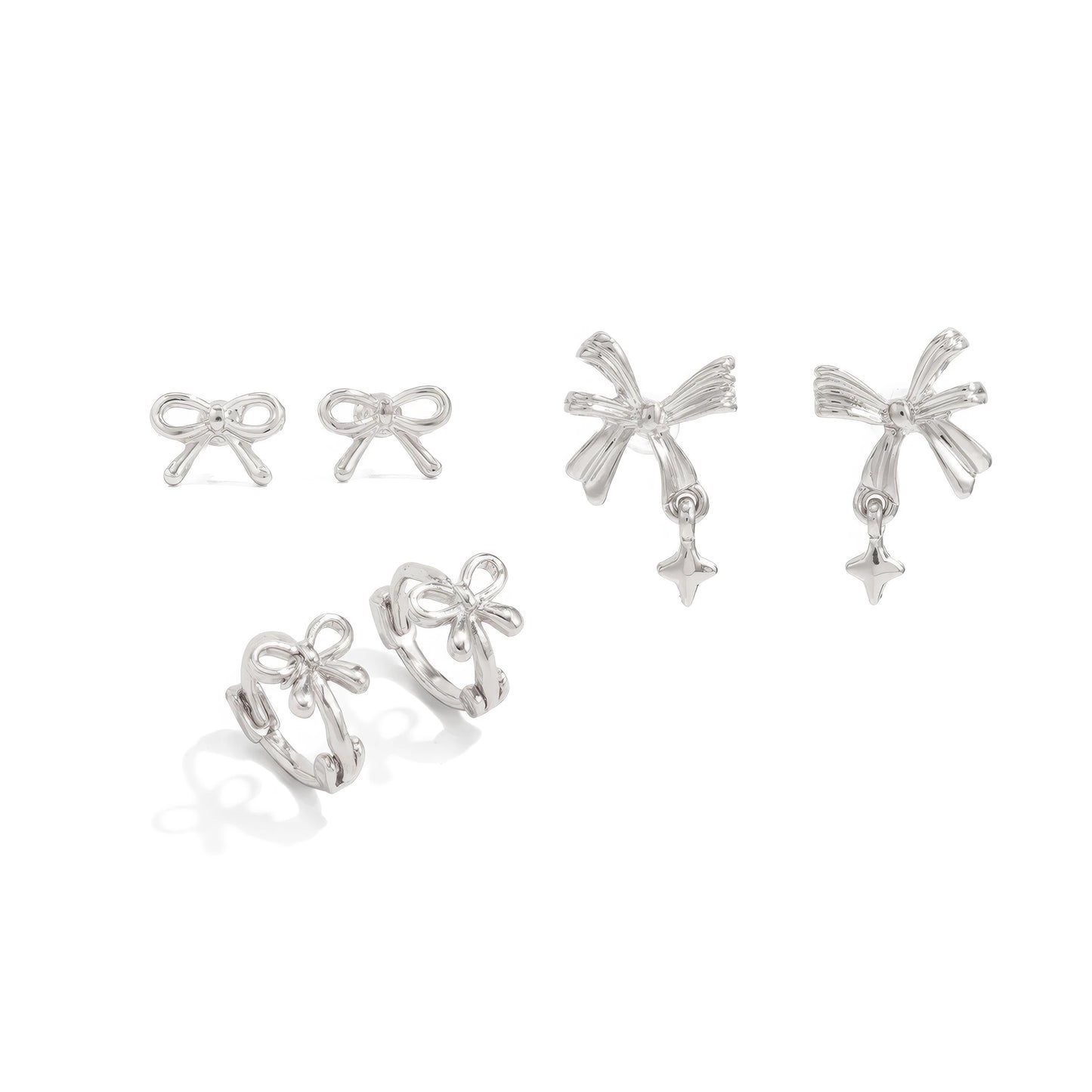 Set of silver bow tie stud earrings isolated on white background.