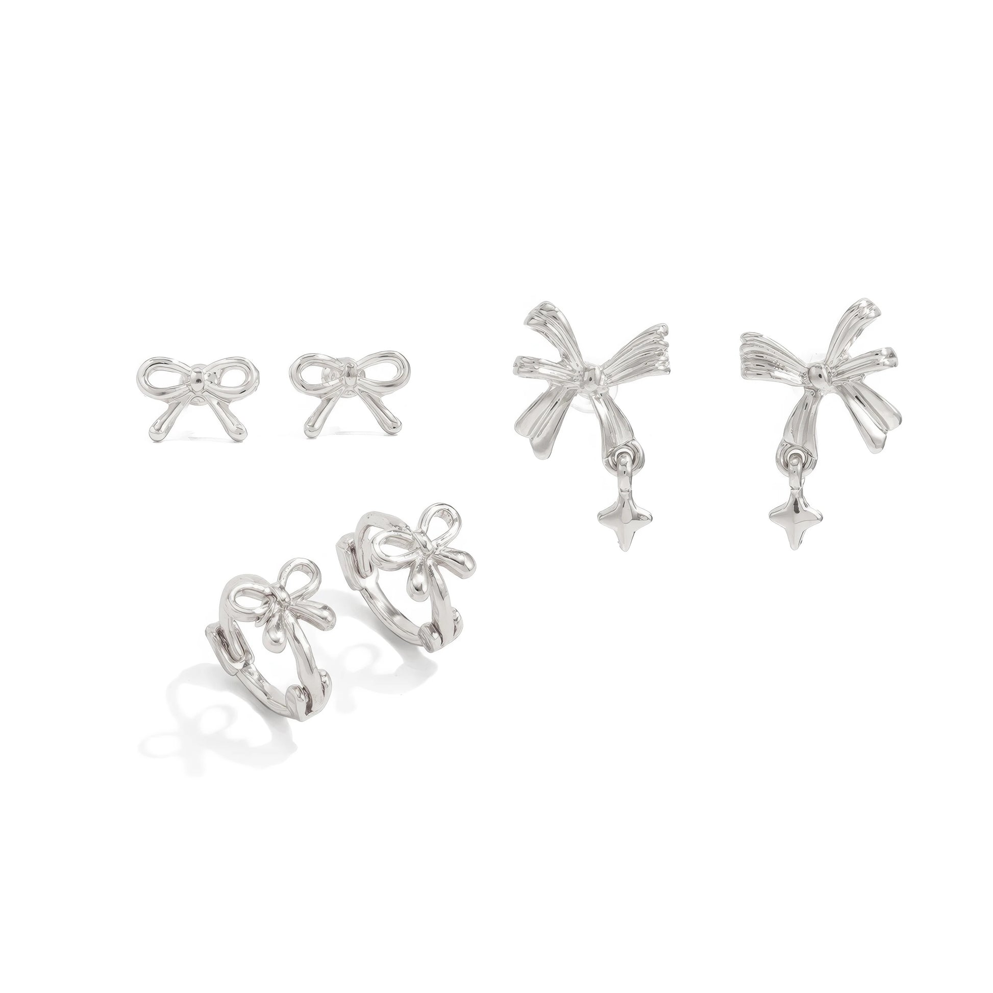 Set of silver bow tie stud earrings isolated on white background.