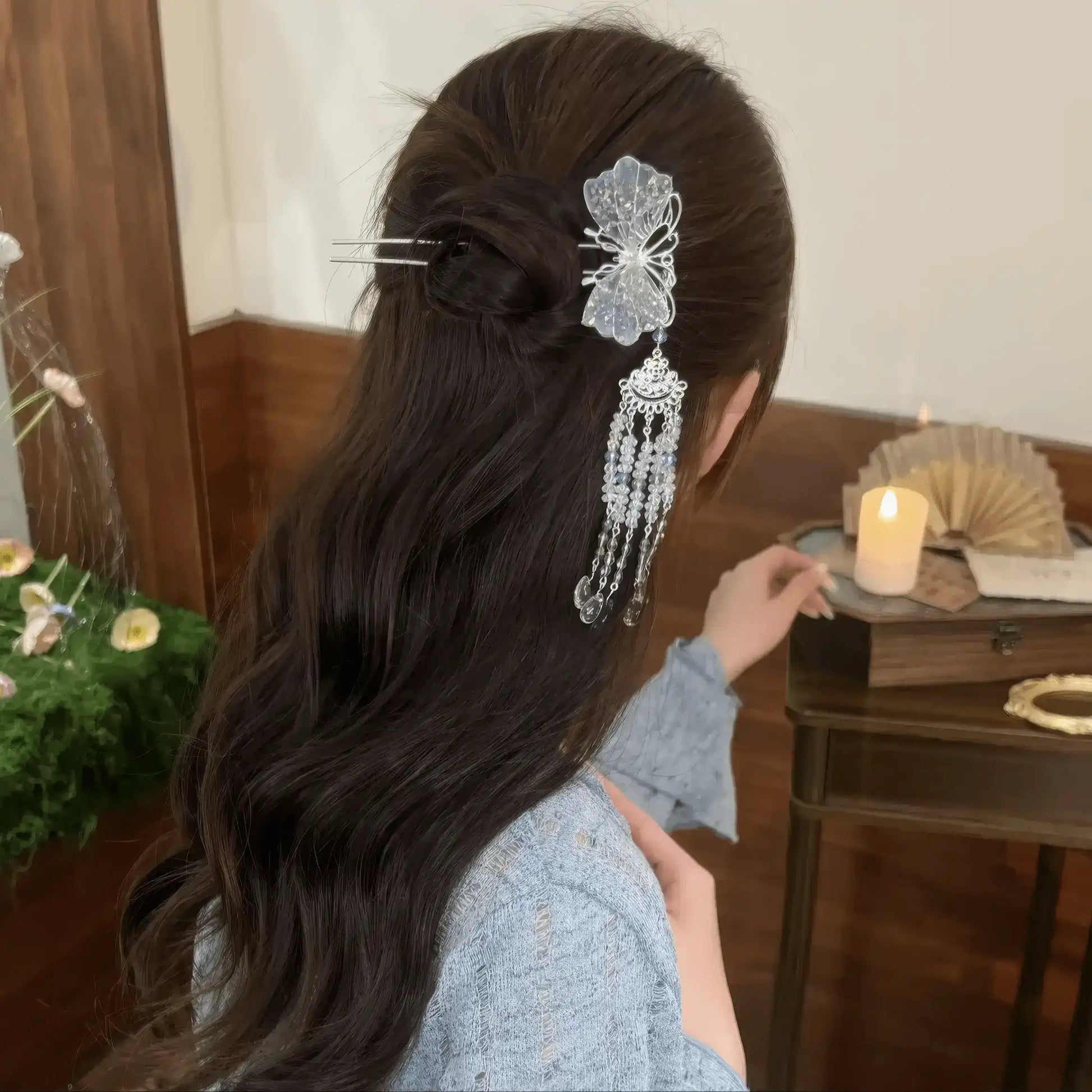 The hairpin styled in loose, wavy half-up hair, showing how the crystal tassels catch the light.