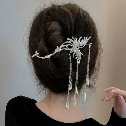 Silver butterfly hair clip styled in a textured messy bun, the sparkling crystals and dangling tassels catching light beautifully.