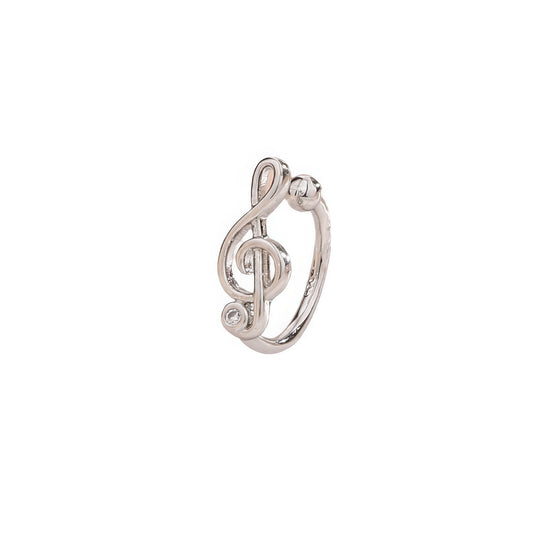 Silver treble clef ear cuff with zircon detailing, isolated on white background, showcasing the musical note design