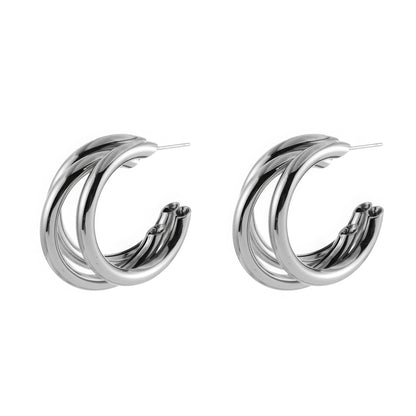 Pair of silver unique - shaped hoop earrings, showcasing the layered, curved design