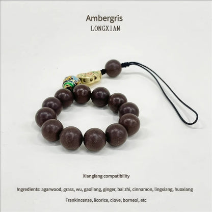  Full - view of the wealth - attracting Chinese medicine incense bead bracelet on a white background, labeled "Ambergris" with text about "Xiangfang compatibility" and ingredient list.