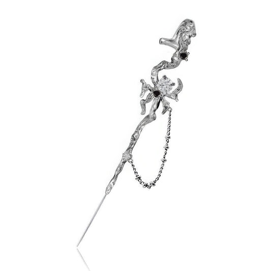 Web - themed trendy piercing ear cuff isolated on white background, showcasing silver metal and spider details.