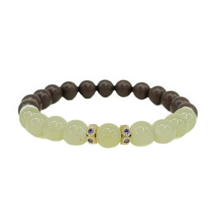  Full - view of the Xiangning natural Chinese medicine bracelet, featuring greenish beads, decorative jeweled spacers, and brown beads.