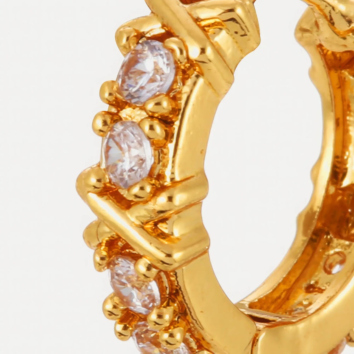  Close - up of gold zircon - inlaid cross hoop earring, showcasing the cross design and embedded zircons