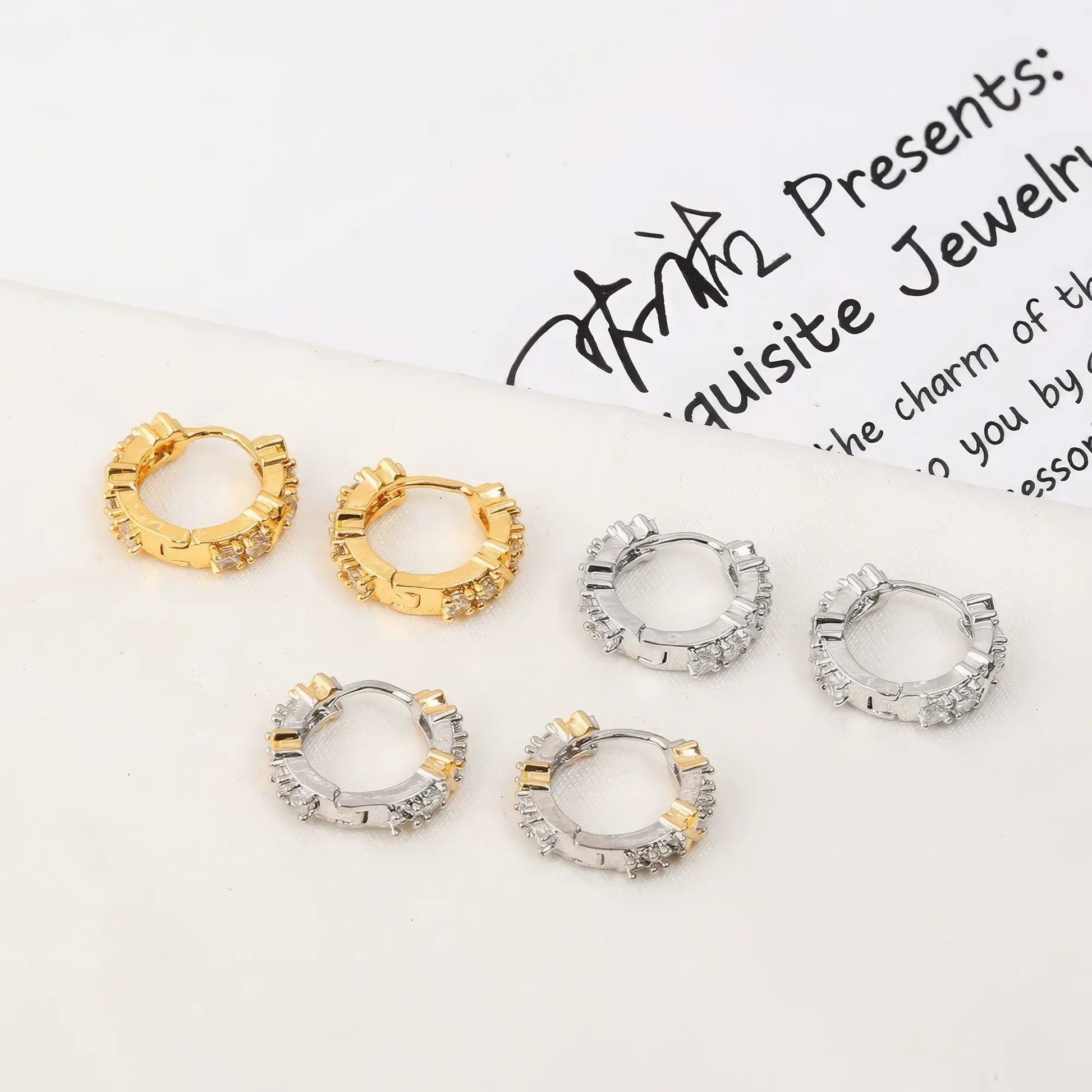 Mixed set of gold and silver zircon - inlaid cross hoop earrings, displayed on a card with text, showcasing the variety of designs
