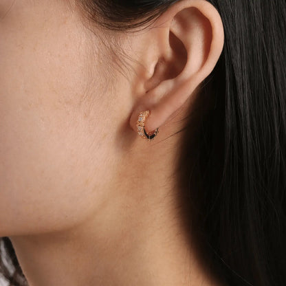 Gold zircon - inlaid cross hoop earring worn, showcasing the delicate and stylish look on the ear