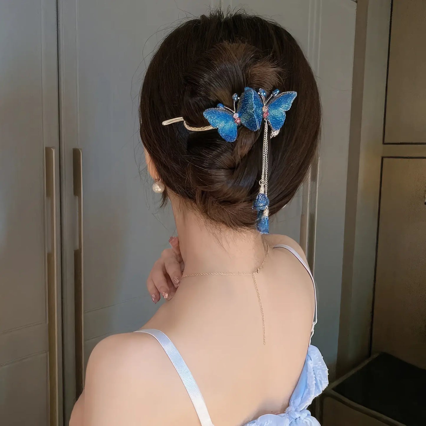Blue butterfly twist clip worn in updo hairstyle (back view)