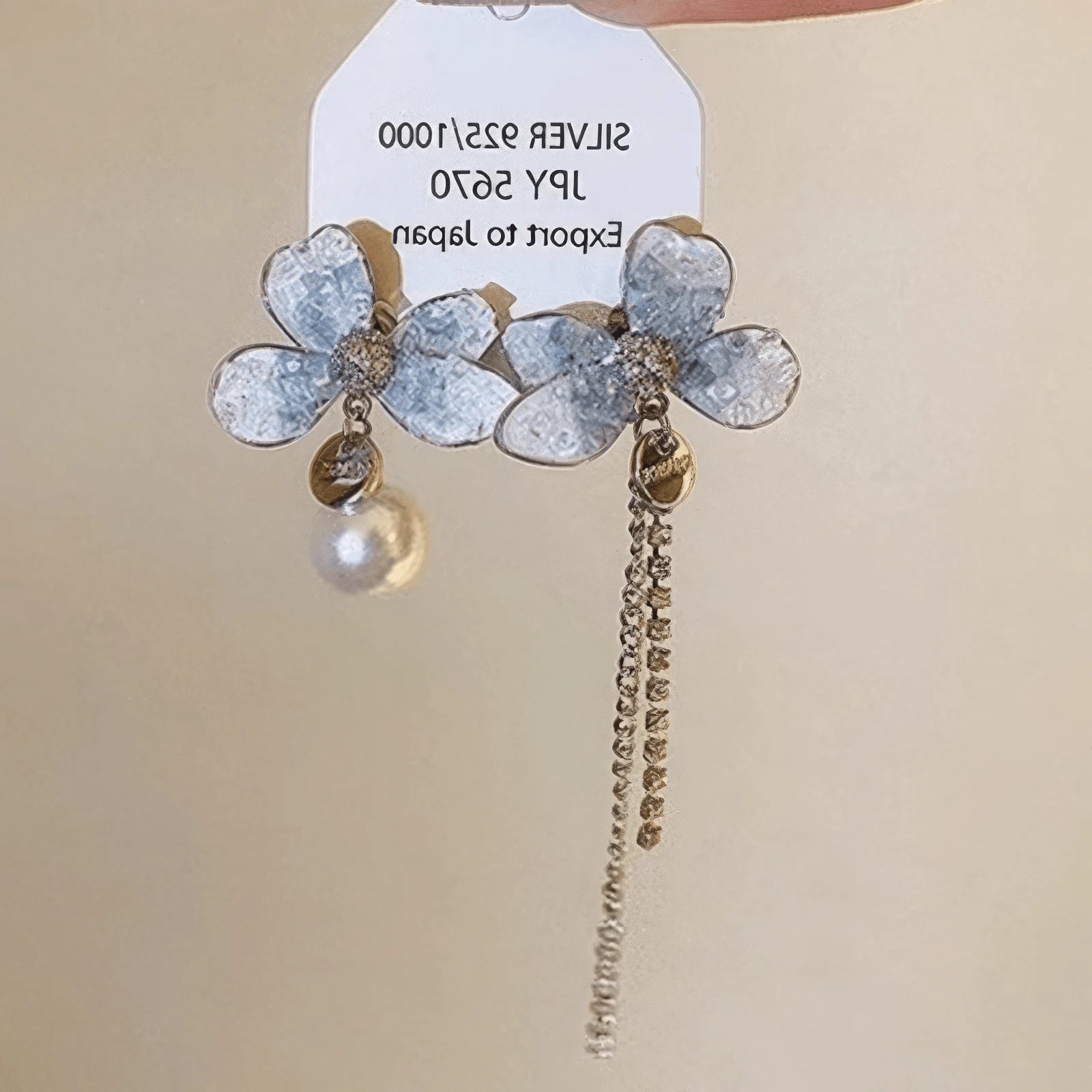 Blue crystal butterfly earrings with chain attached to a card