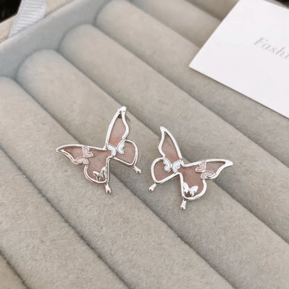 Blue crystal butterfly - outline earrings on a display tray