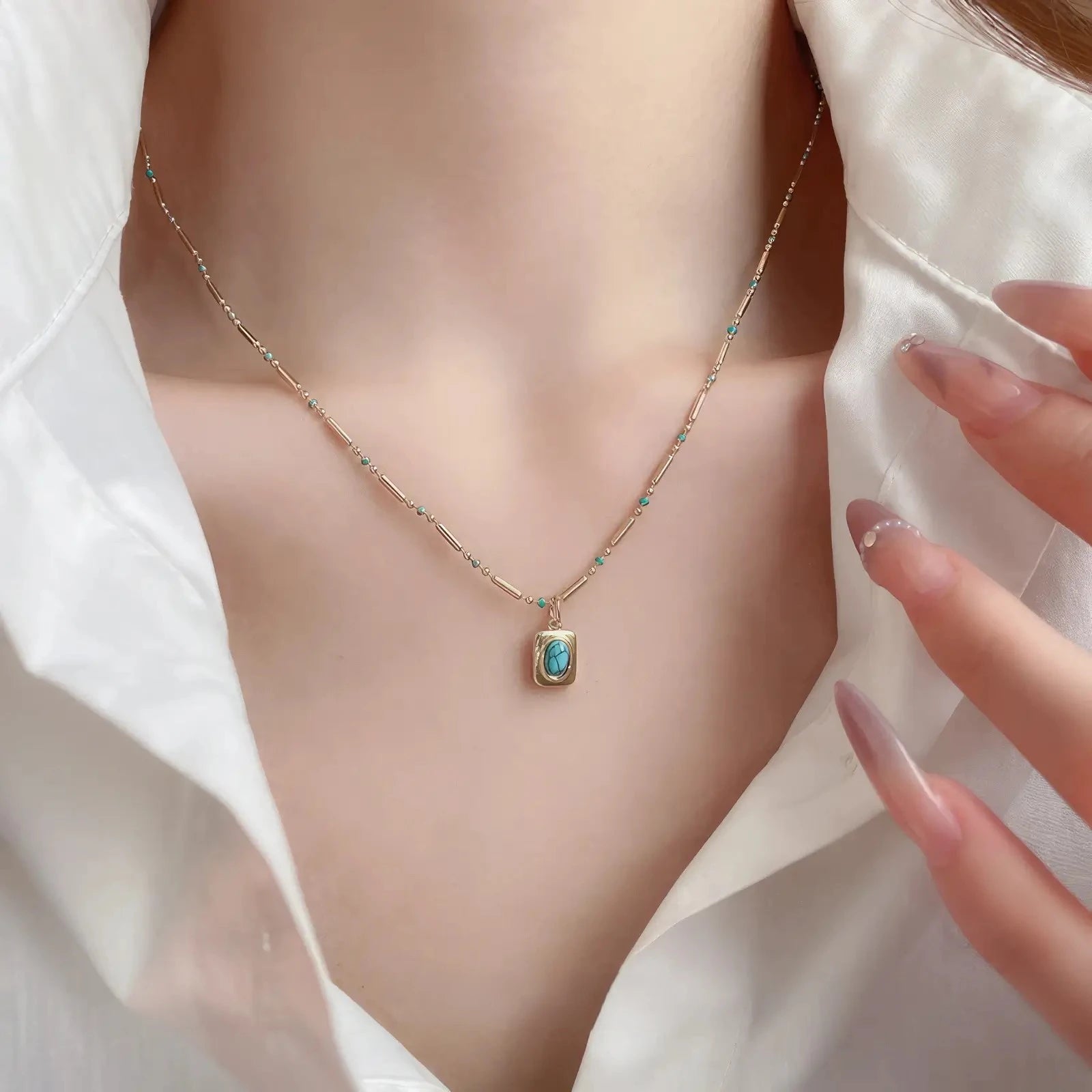 Bohemian stone bead necklace with pendant, turquoise stone, worn on white shirt