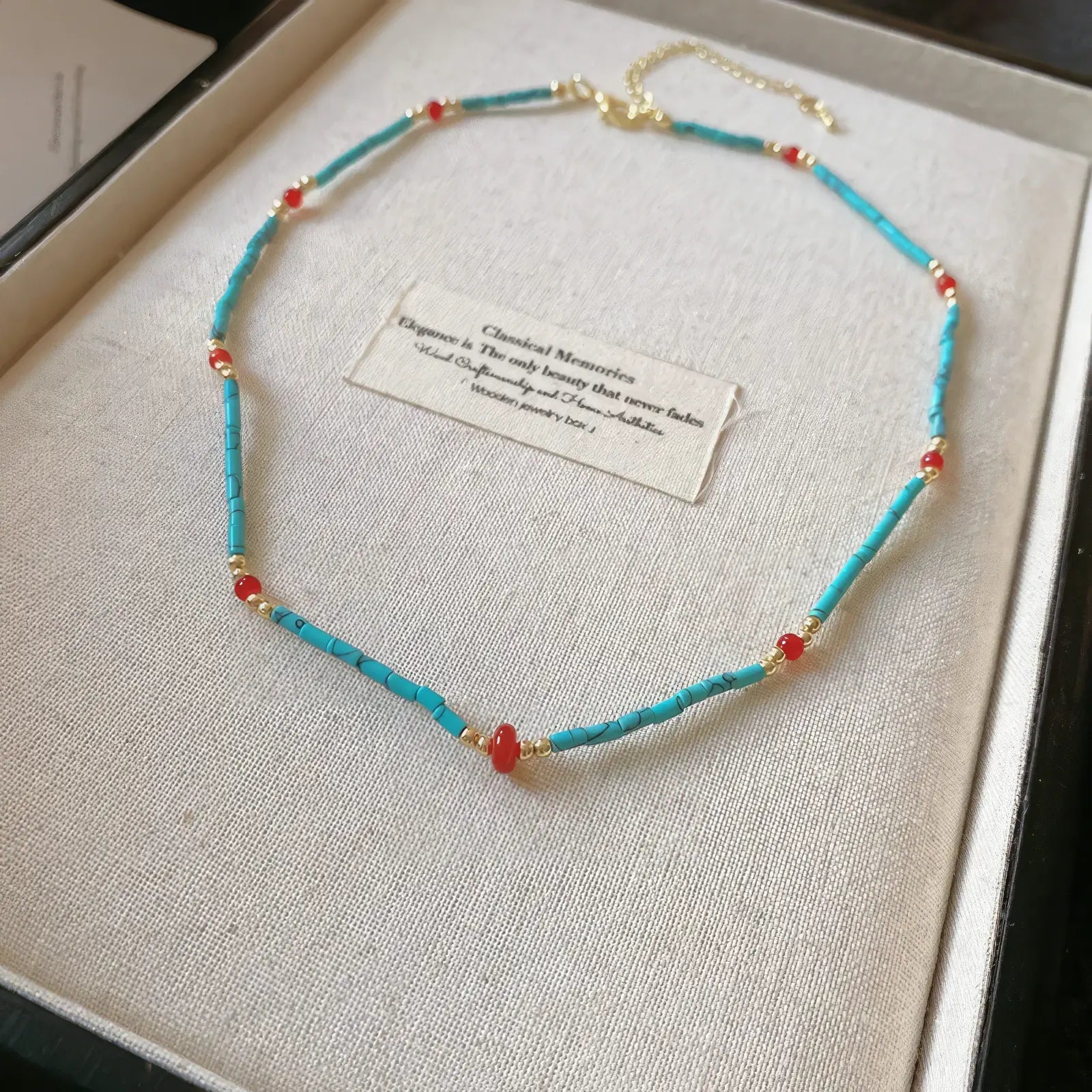 Single - layer bohemian stone bead necklace, turquoise and red beads, displayed in box