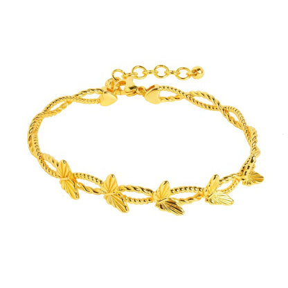 Gold butterfly bracelet, isolated on white background, showcasing delicate design