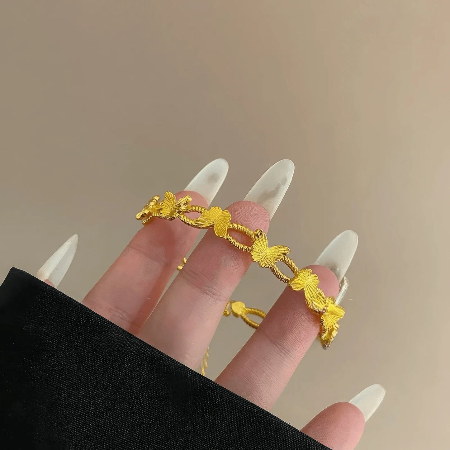 Gold butterfly bracelet placed on hand, showcasing design details
