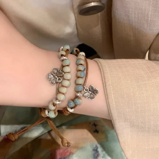 Double butterfly ceramic beaded bracelets worn on a wrist