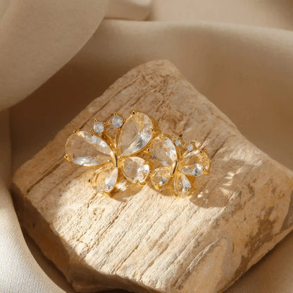 Gold butterfly diamond brooch, placed on stone, emphasizing elegance
