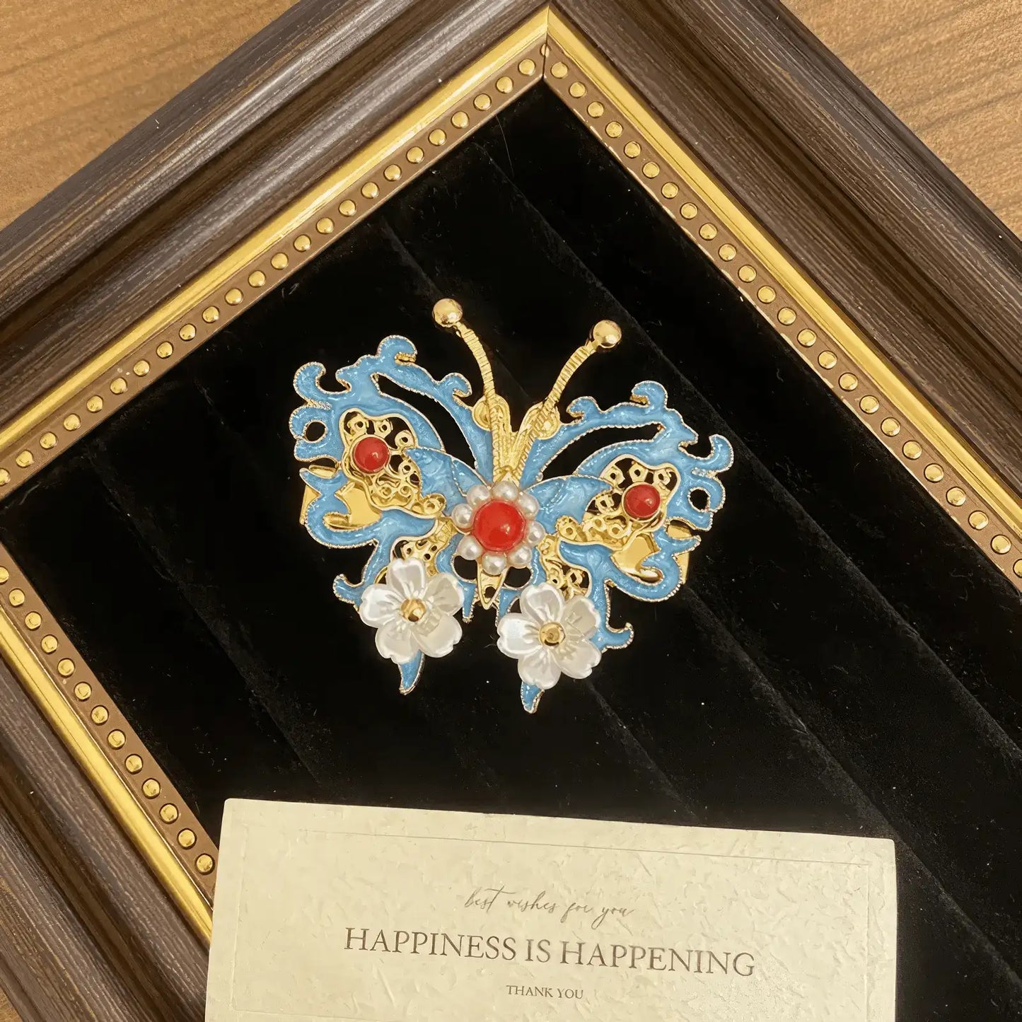 Butterfly and flower hair clip set, blue and gold with pearls and gems, in a dark velvet and gold - framed display