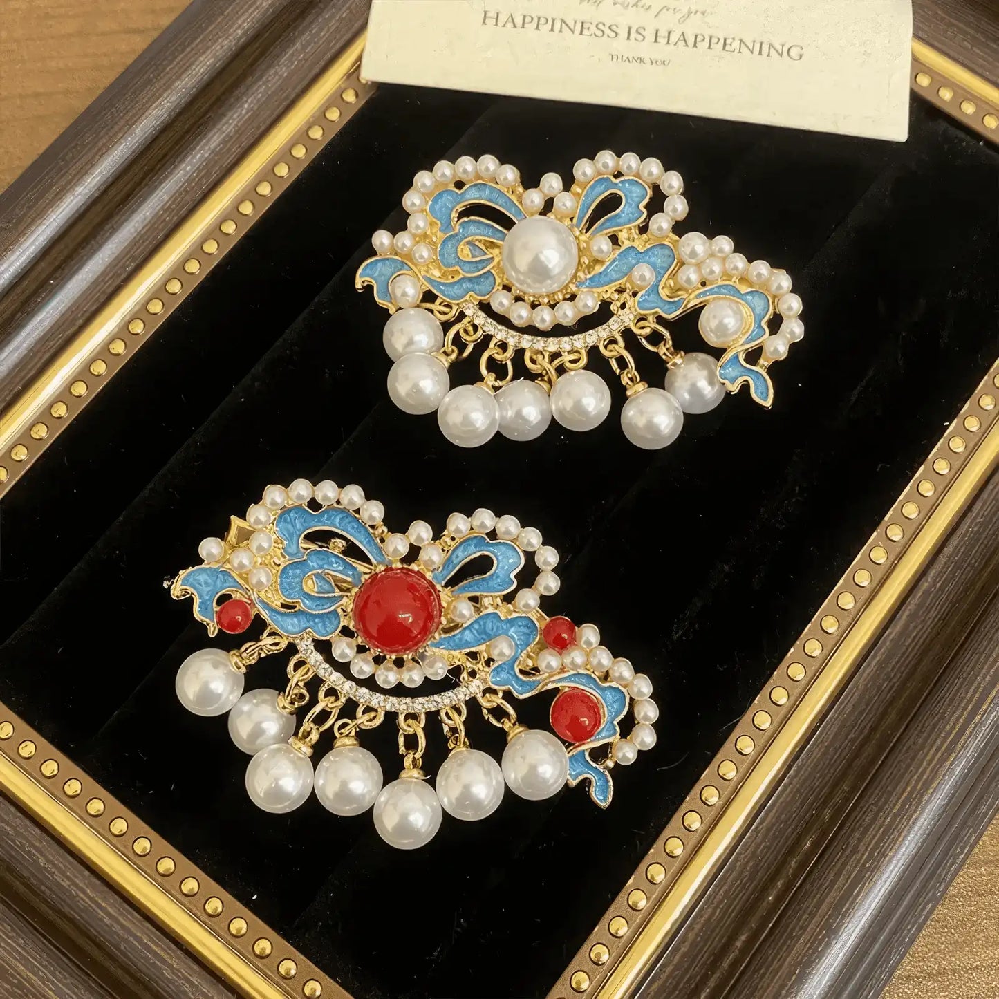 Butterfly and flower hair clip set, different arrangement of blue and gold clips with pearls, in a display frame