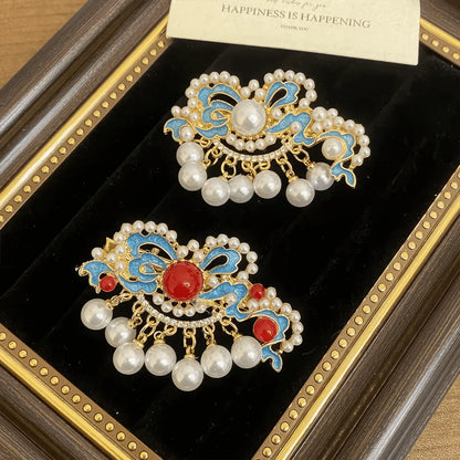 Butterfly and flower hair clip set, different arrangement of blue and gold clips with pearls, in a display frame