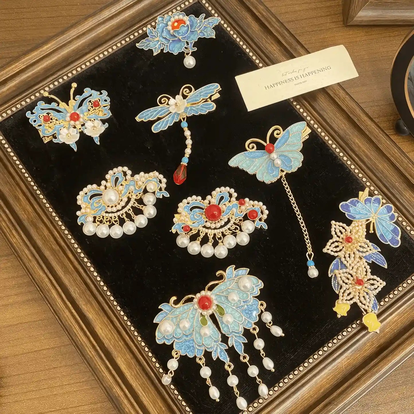 Butterfly and flower hair clip set, featuring a combination of butterfly and flower designs in blue and gold, in a decorative frame