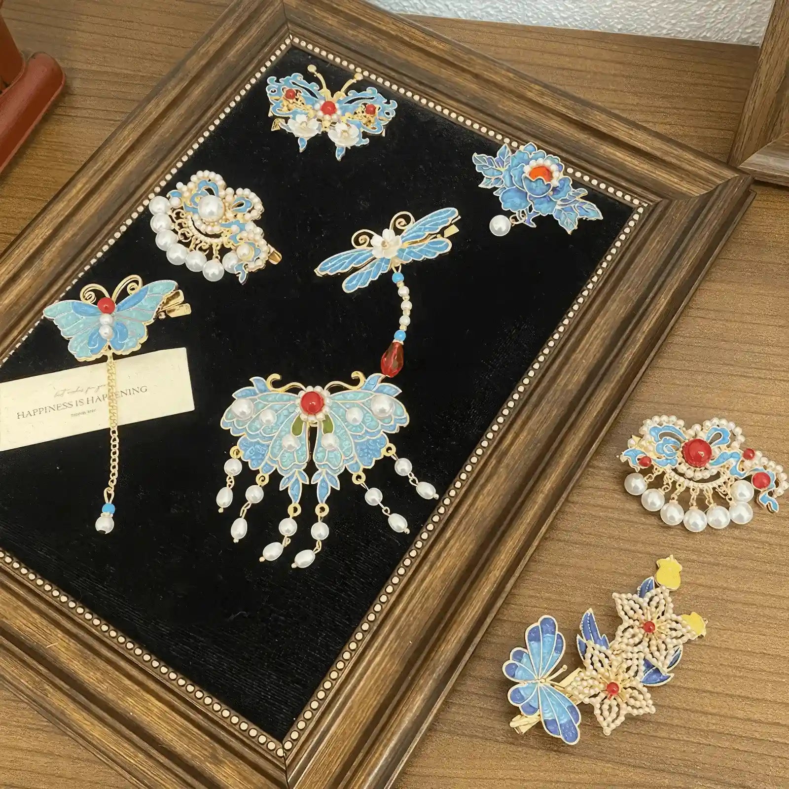 Butterfly and flower hair clip set, blue - themed with gold accents and pearls, presented in a display