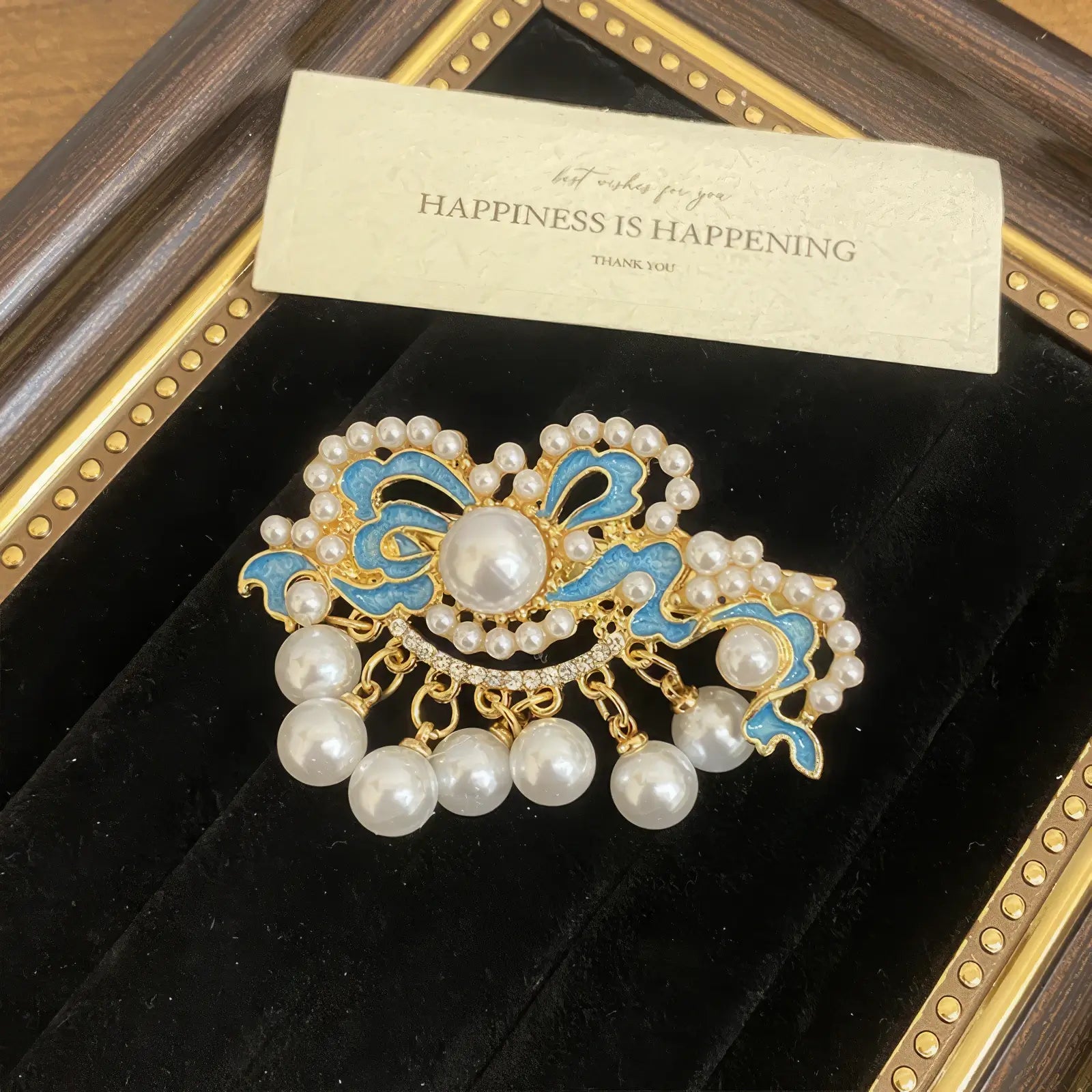 Butterfly and flower hair clip set, with a mix of butterfly and flower shapes in blue and gold, in a framed display