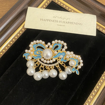 Butterfly and flower hair clip set, with a mix of butterfly and flower shapes in blue and gold, in a framed display