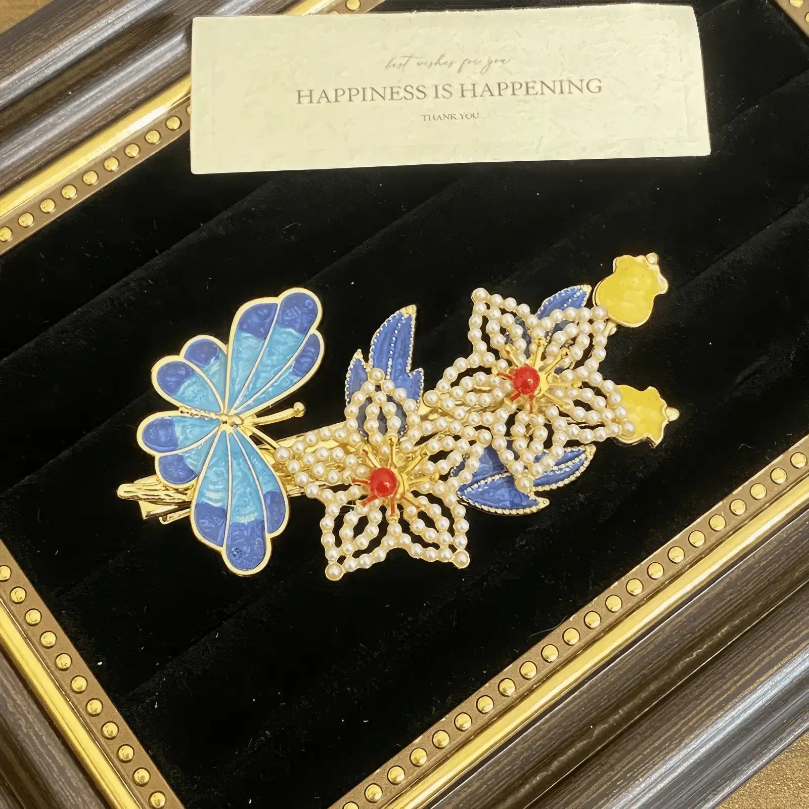Butterfly and flower hair clip set, featuring blue butterflies and gold flowers with pearls, in a display frame