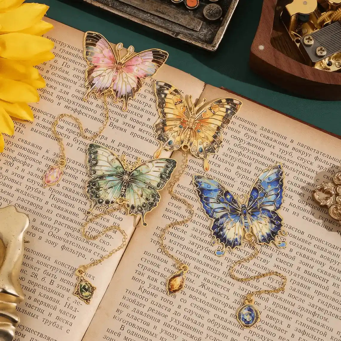 Butterfly in painting series oil painting bookmarks, multiple designs, displayed on open books with sunflowers in background