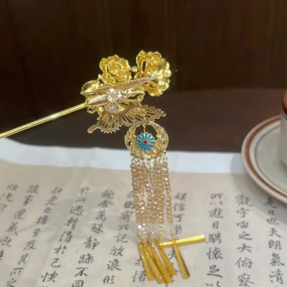 Closeup of butterfly-peony design on tassel hairpin, set against calligraphy background