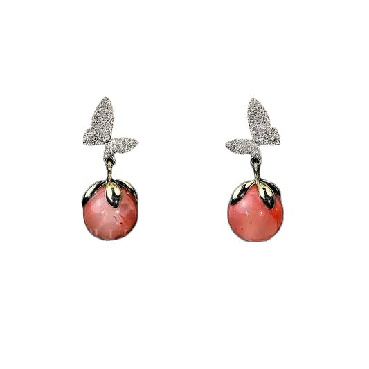 Butterfly pink cat's eye stone earrings, isolated on white background