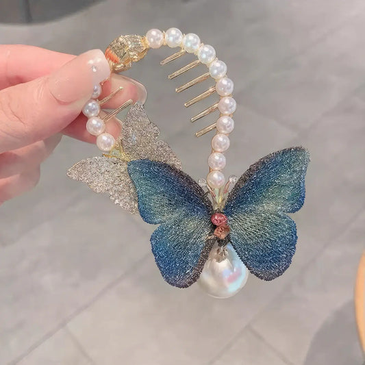 Detail view of the blue butterfly - shaped updo tool with pearls and a metal comb