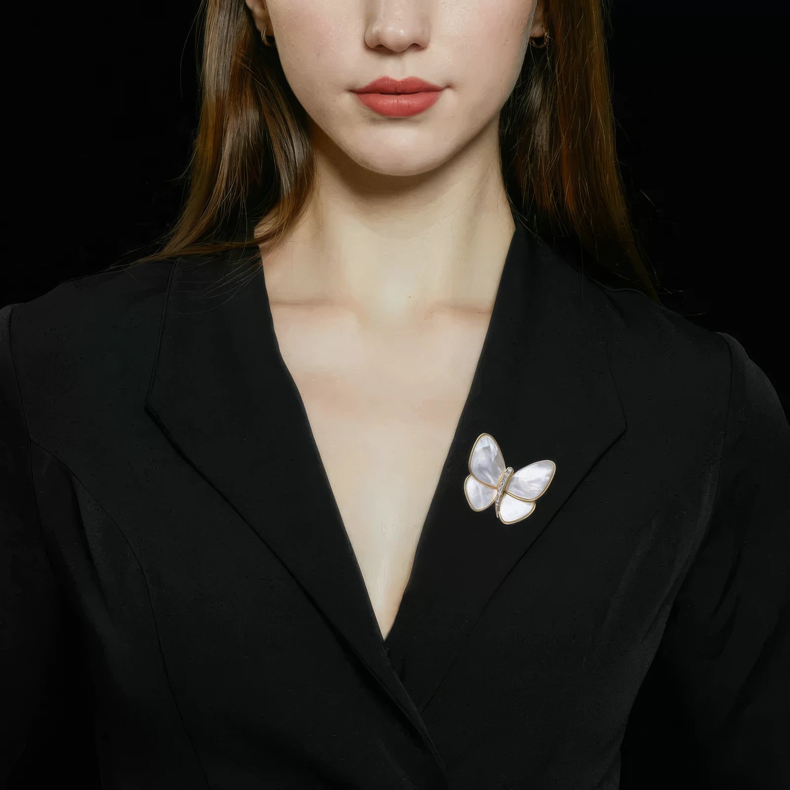 White butterfly brooch worn on black blazer, showcasing understated elegance
