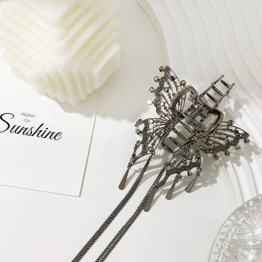 Black cat - eye stone butterfly claw clip displayed on white surface with “Sunshine” card