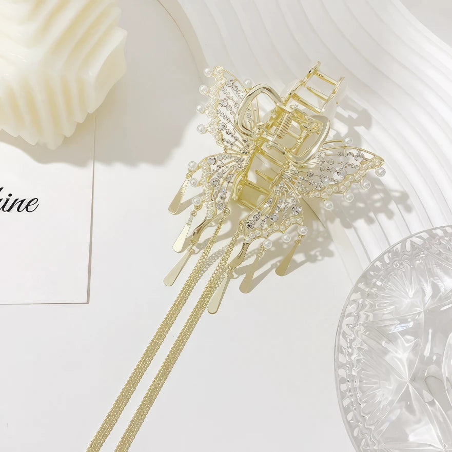 Gold cat - eye stone butterfly claw clip isolated on white background with decor