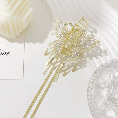 Gold cat - eye stone butterfly claw clip isolated on white background with decor